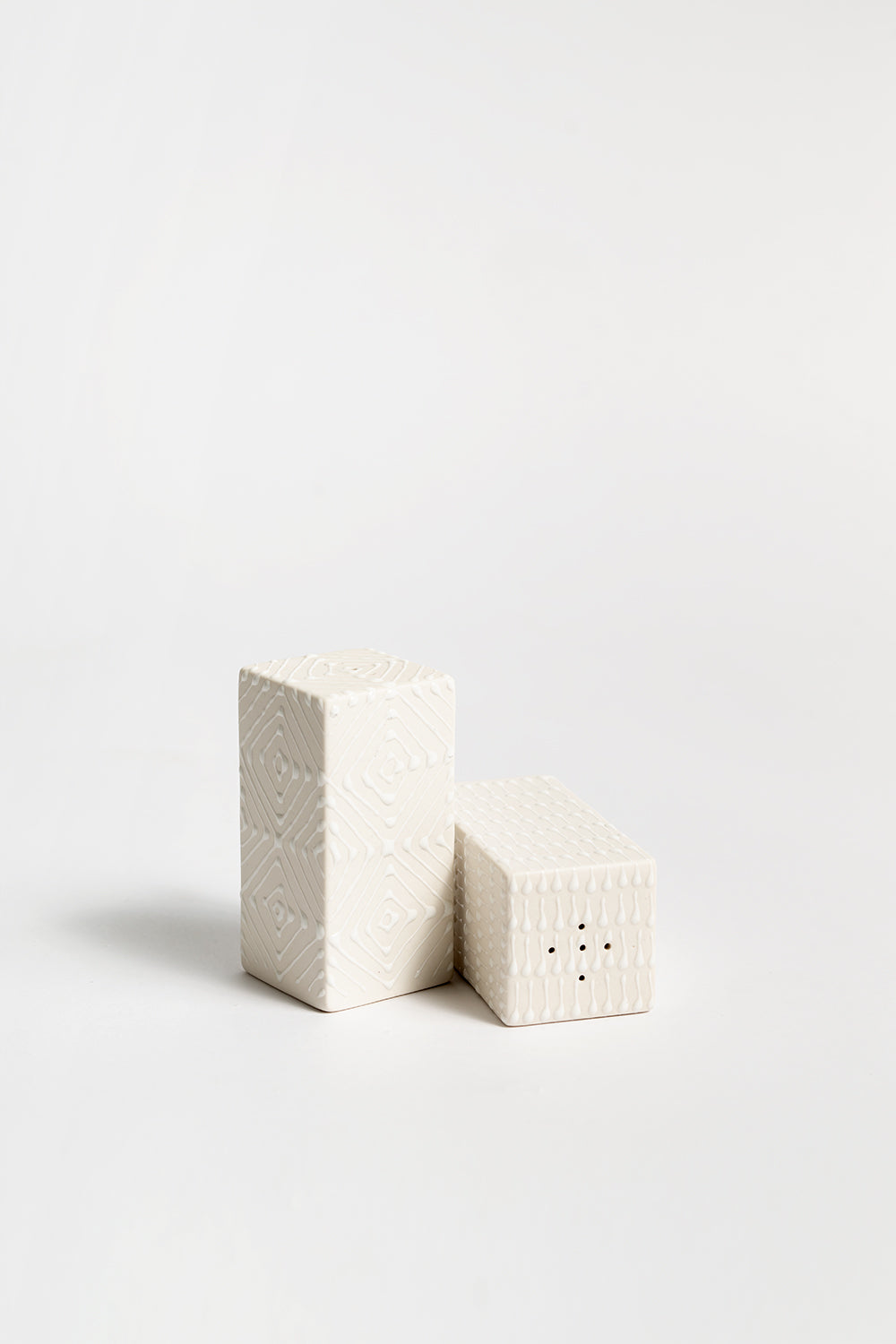 A pair of ceramic salt and pepper shakers with a geometric pattern 